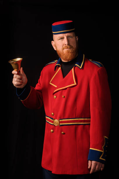 Historical Bell Boy in studio shoot Historical Redhead Bell Boy in studio shoot town criers stock pictures, royalty-free photos & images