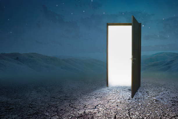 istock Opened door with white light on the spooky hill 1257182324