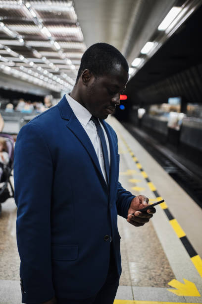 istock Businessman using smart phone on subway station 1257184916
