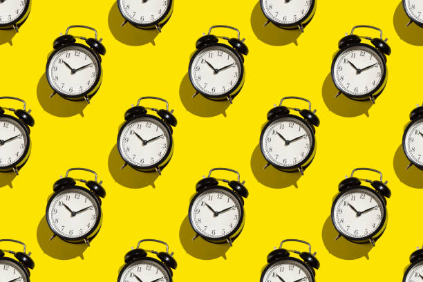 istock Vintage alarm clock on yellow background. Abstract pattern 1257185768