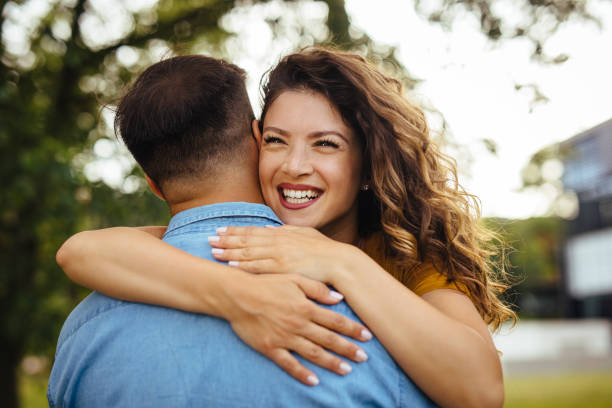 istock Couple in love embracing in spring park 1257188648