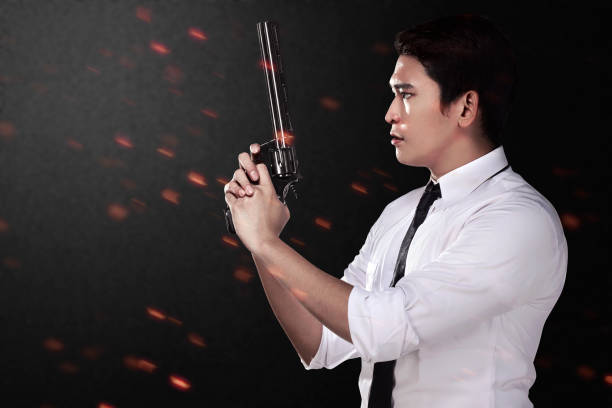 Frustrated man holding a gun towards the camera.