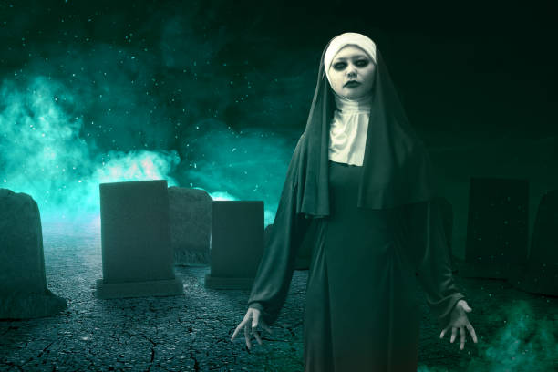 istock Frightening devil nun standing with mystical fire on the graveyard 1257189141