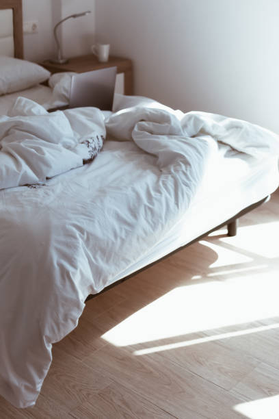 istock Working home isolation concept. Laptop in bed 1257190054