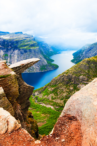 Panoramic view of Trolltunga landmark in Norway. Beautiful summer landscape, view of lake with mountains. Famous travel destination