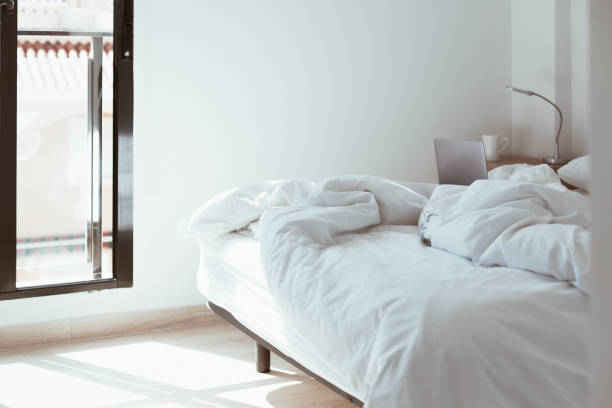 istock Working home isolation concept. Laptop in bed 1257190185