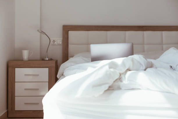 istock Working home isolation concept. Laptop in bed 1257190249