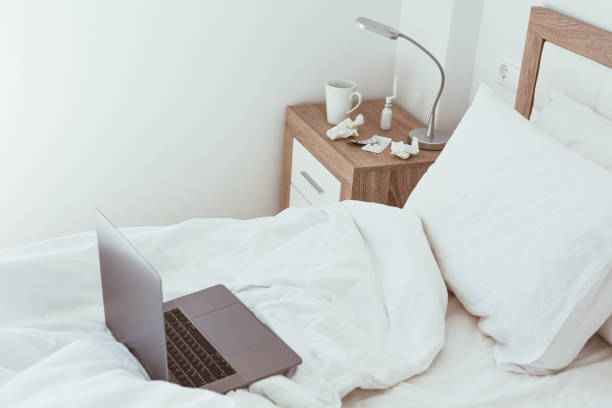 istock Working home isolation concept. Laptop in bed 1257190324