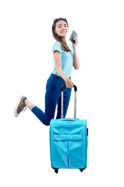 istock Asian woman standing with a suitcase holding passport 1257190706