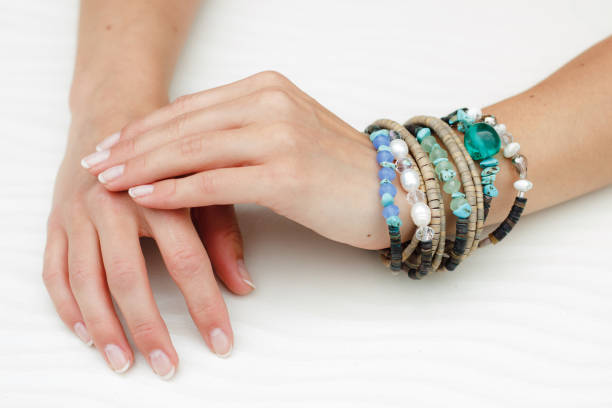 istock Bracelets on a beautiful woman's hands with manicure 1257190760