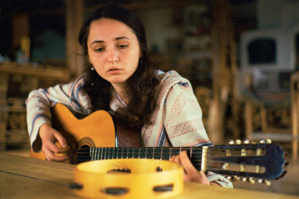istock Woman playing guitar 1257191454