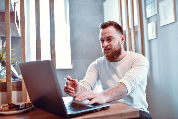 istock Handsome Male Working On Laptop With Snacks 1257194224
