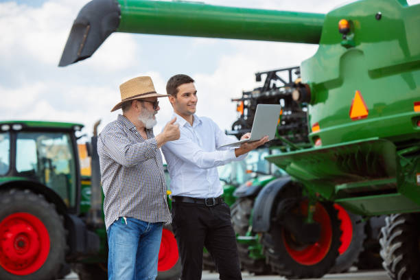 istock A farmer with a tractor, combine at a field in sunlight. Confident, bright colors 1257195047