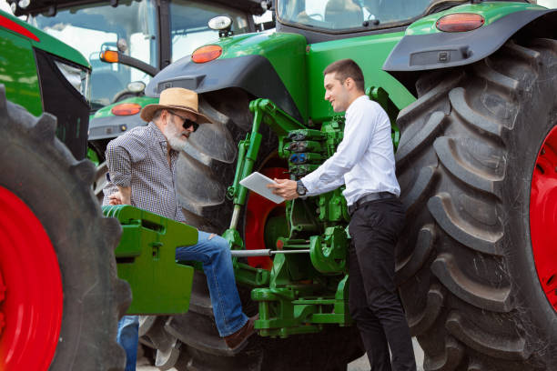 istock A farmer with a tractor, combine at a field in sunlight. Confident, bright colors 1257195061