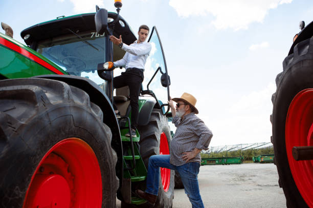 istock A farmer with a tractor, combine at a field in sunlight. Confident, bright colors 1257195079
