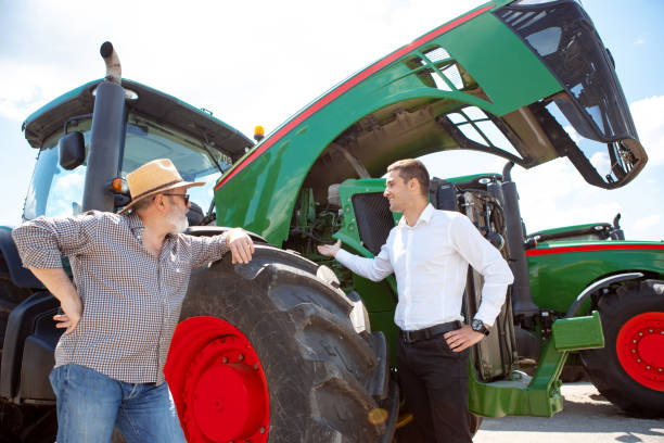istock A farmer with a tractor, combine at a field in sunlight. Confident, bright colors 1257195090