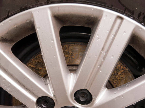 istock Car corroded brake disk with alloy wheel side view 1257195662