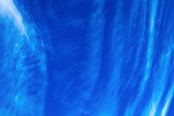 istock Abstract white clouds in the form of vertical stripes on a blue sky background 1257197153