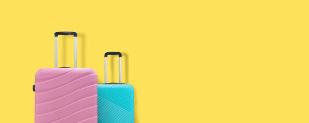 istock Two suitcases on a yellow background. Copy space 1257198963