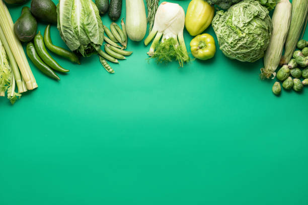 istock Flat lay pattern with green vegetables on green background. Healthy food concept. 1257199137