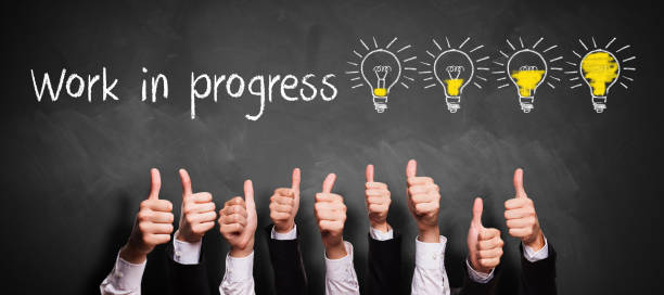 istock thumbs up gesture in front of a chalkboard with message WORK IN PROGRESS 1257199189