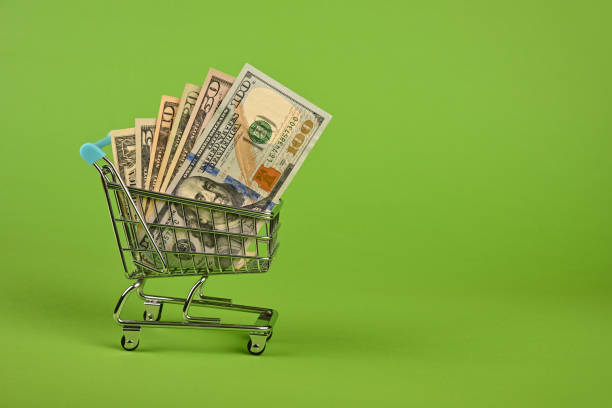 istock US dollar banknotes in shopping cart over green 1257199204