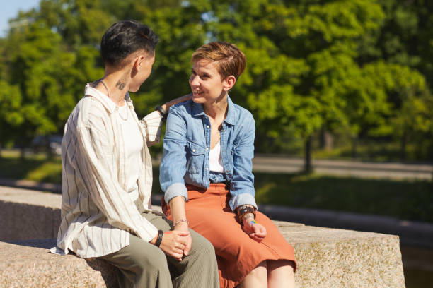 istock Two women sitting in the park 1257199572