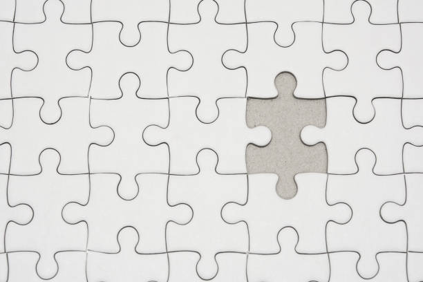 istock White jigsaw puzzle pattern background. placing last piece of jigsaw puzzle 1257199581