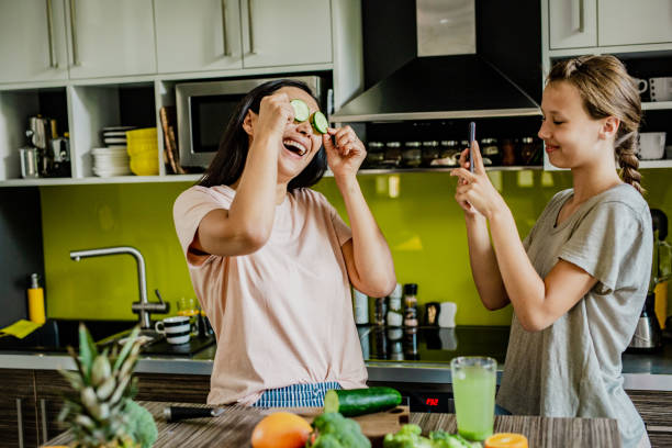 istock Mom and daughter having fun in the kitchen 1257201536