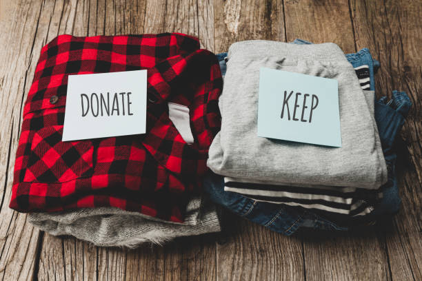 istock Stack of old clothes to discard (declutter) or keep. Recycle clothes, eco cotton 1257204684