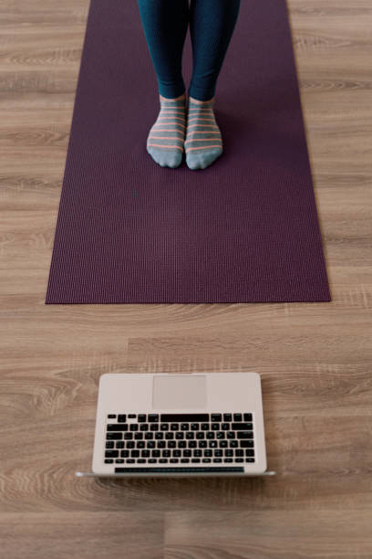 istock Woman legs practicing yoga at home 1257204692