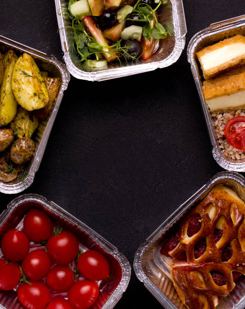 istock Food Delivery Concept. Different food containers on black background. Copy space 1257205635