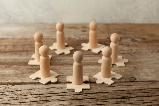 istock Wooden figures on puzzles. People analytics and optimization, team building. Group connection in business 1257205652