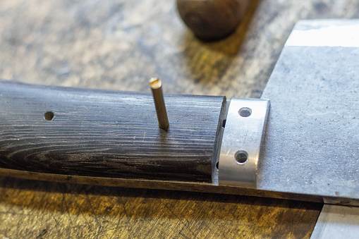 Close-up of a man using electric circular saw at carpentry