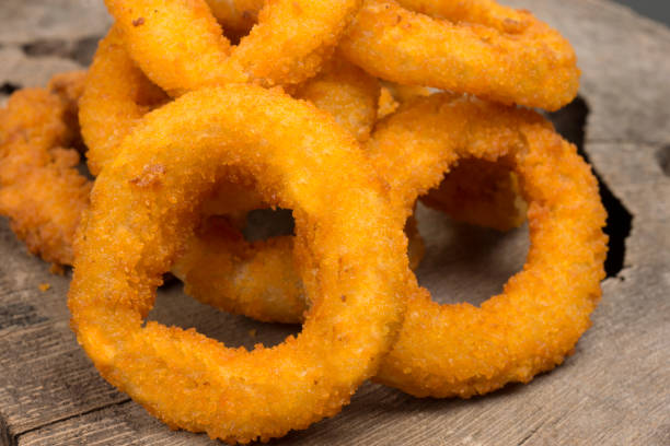 istock Onion rings in  rustic wood background close 1257209086