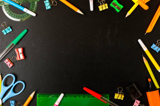 istock Frame of school stationery on a black school board. 1257210150