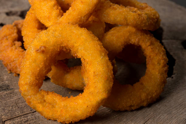 istock Onion rings in  rustic wood background close with half light 1257210416