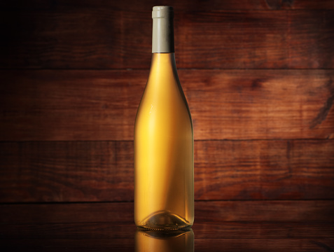 full wine bottle without label on wooden background