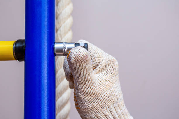 istock Assembling installing home gymnastic wall bars on the floor. Sport gym home concept 1257212158