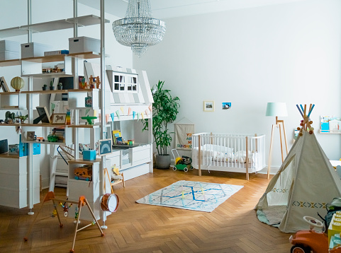 Interior of empty playroom. Toys and furniture at home. Tent in apartment.