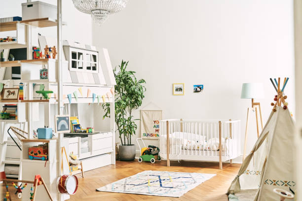 Toys and furniture at home. Interior of playroom with white walls. Tent in apartment.