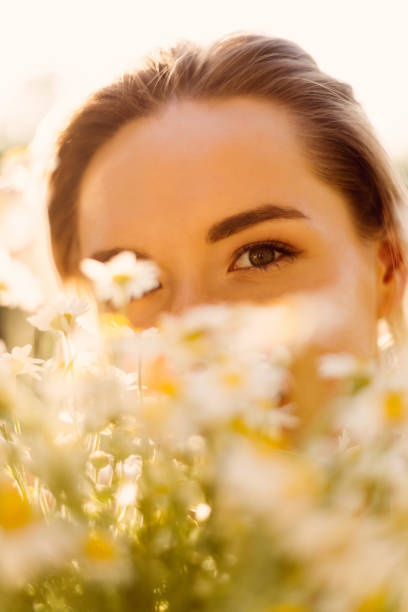 istock Beautiful woman with chamomile flowers 1257214543