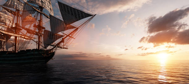 istock Pirate ship sailing on the ocean at sunset 1257217807