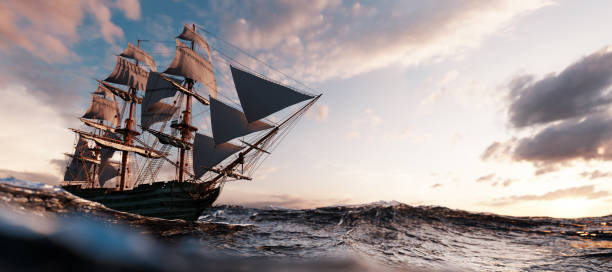 istock Pirate ship sailing on the ocean at sunset 1257217809