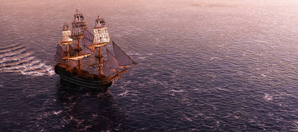 istock Pirate ship sailing on the ocean at sunset 1257217833