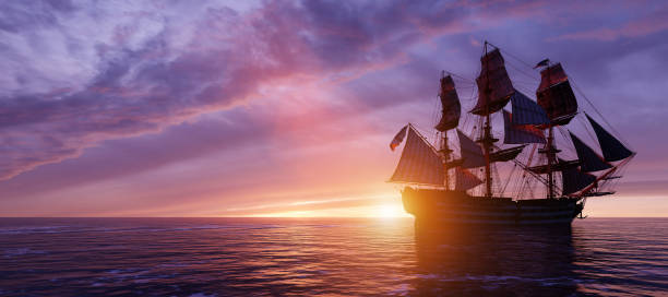 istock Pirate ship sailing on the ocean at sunset 1257217853