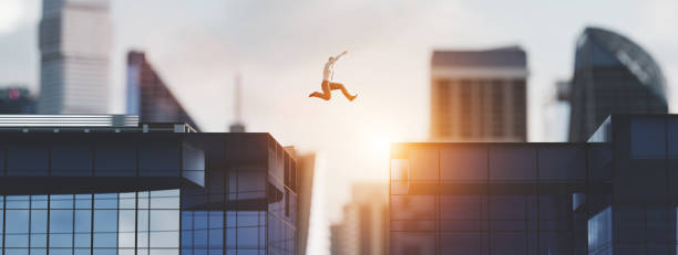 istock Man jumping between skyscrapers. Business success 1257217884