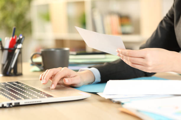 istock Entrepreneur hands working on laptop holding receipt at home 1257218876