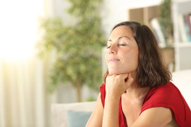 istock Satisfied middle age woman relaxing at home 1257219495