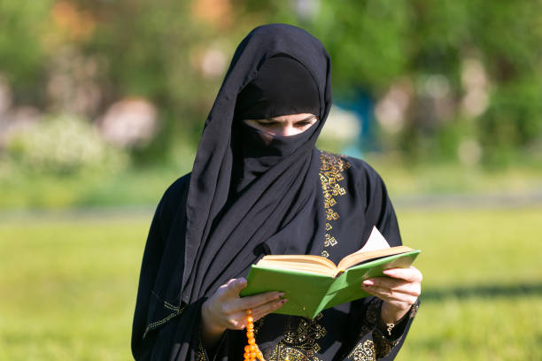 istock A woman from the East performs morning prayer while. 1257220300